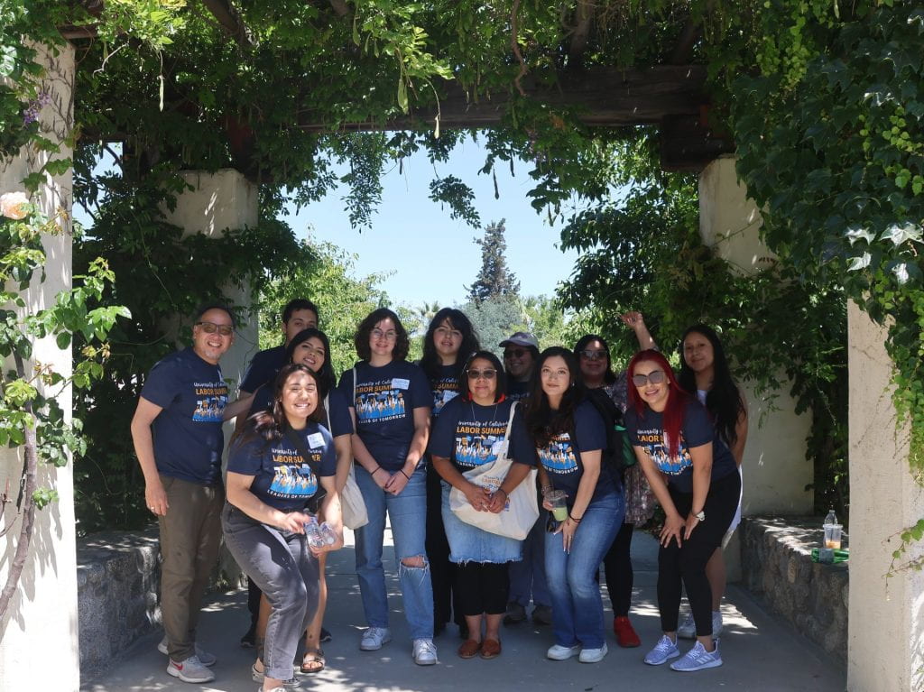 students and faculty group photo in labor summer shirts